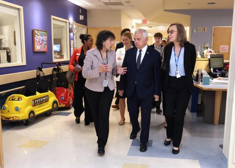 Bertagnolli talks with Reed while walking through a clinic
