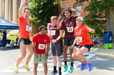  Team Calbindin Snap, wearing shades of red and maroon, leap in excitement.