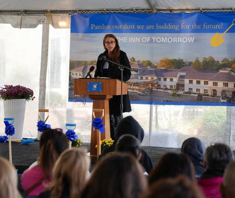 Gentille speaks at a podium