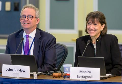 Burklow and Bertagnolli sitting together, smiling, with their laptops