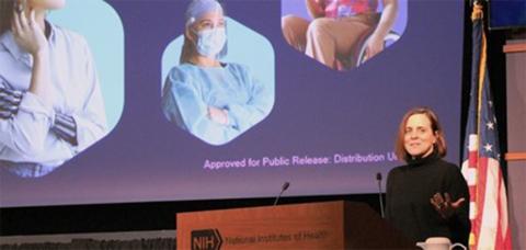 Wegrzyn at podium in Natcher with outstretched palm