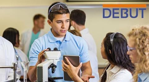 Students chat; DEBUT sign on wall behind them