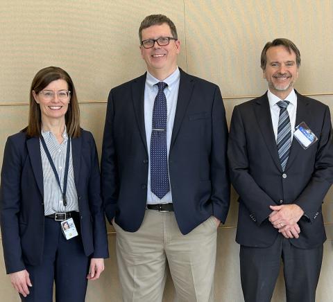 Read, Pierson and Plescia stand smiling, inside the VRC