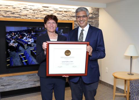 Bertozzi and Bhattacharya hold up Bertozzi's award