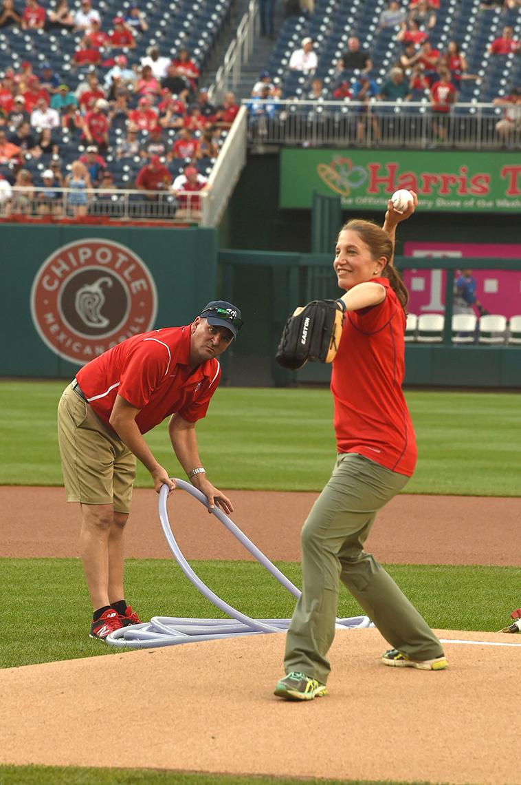 HHS secretary throws from the mound.