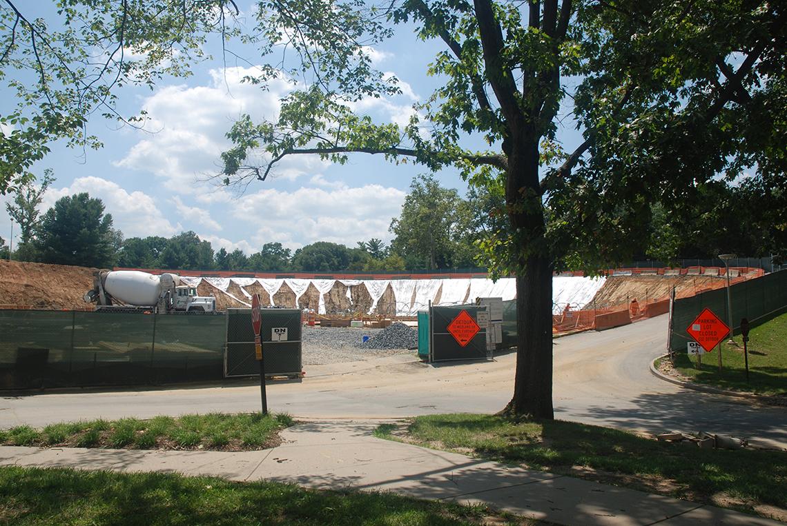 Excavated construction site surrounding a cement mixer