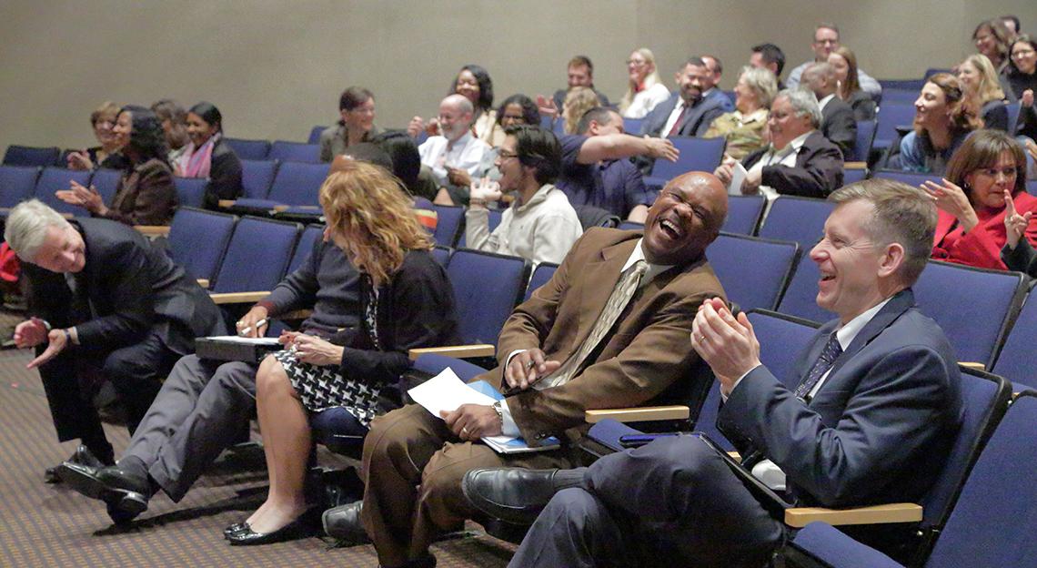 Audience members laugh 