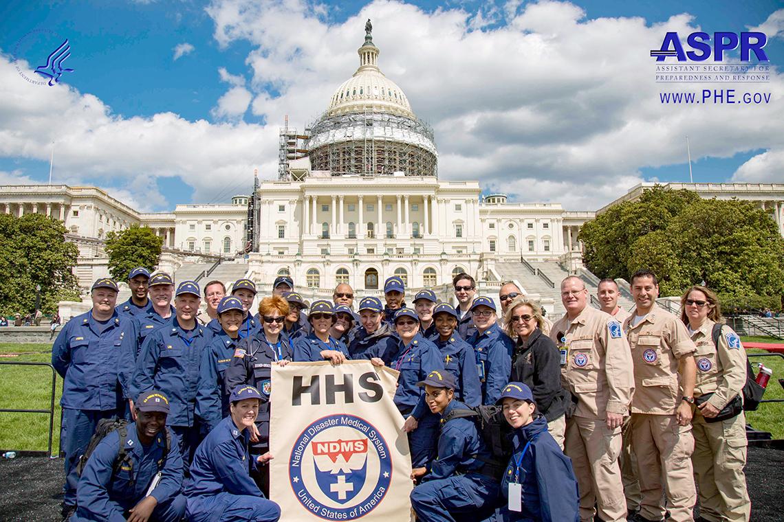 Large group of uniformed people stand in front of the U.S. Capitol