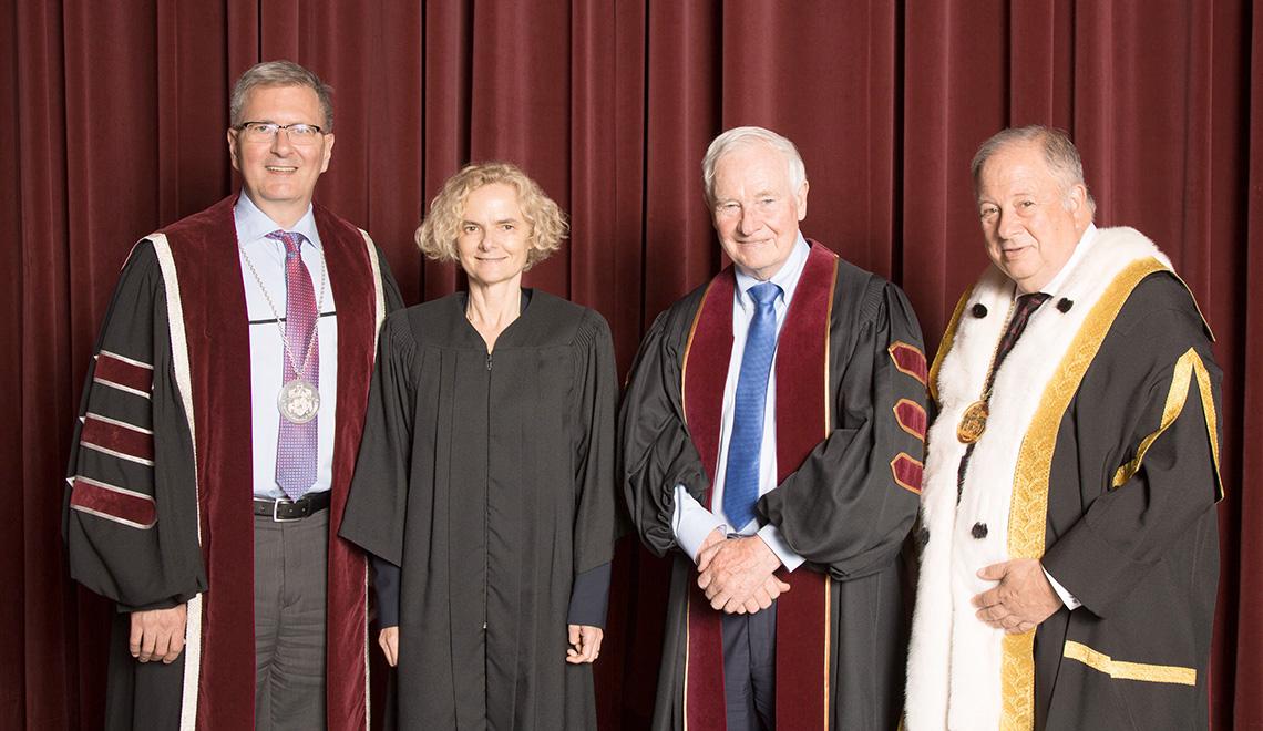 Shepard, Volkow, Johnston and Wener smile wearing graduation ceremony gowns