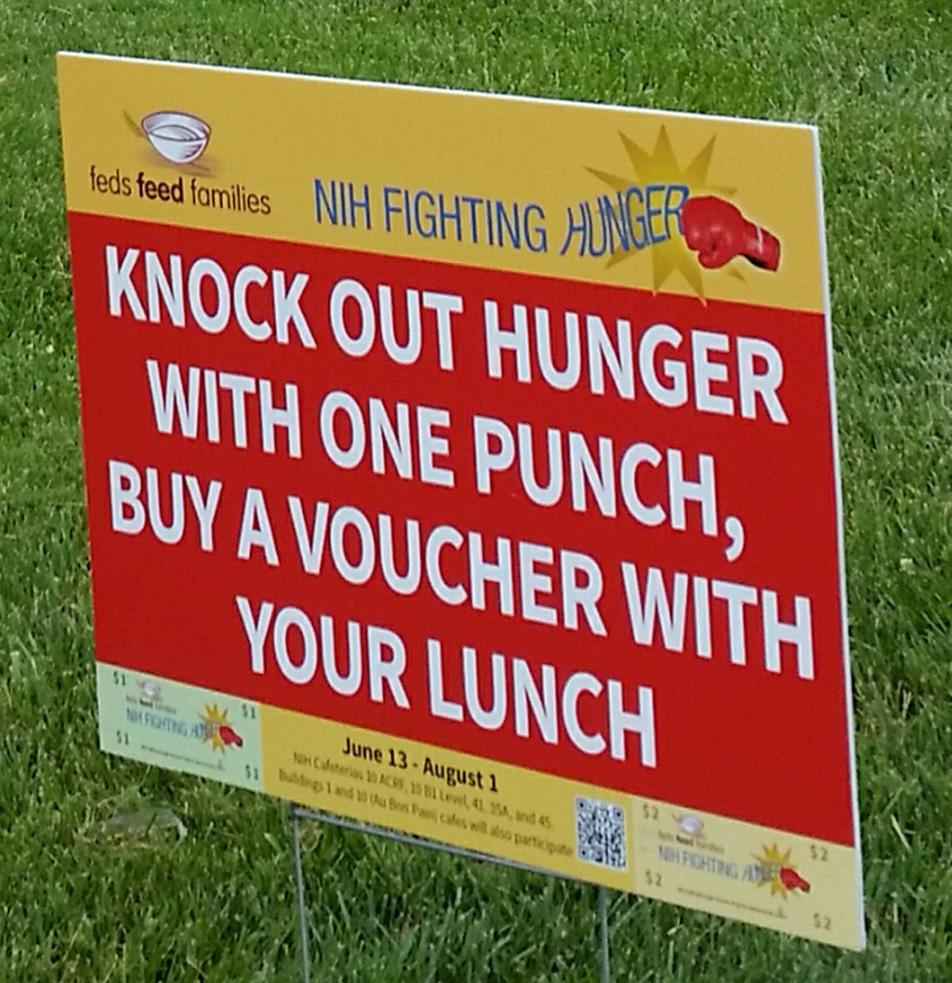 Red sign on lawn reads: knock out hunger with one punch, buy a voucher with your lunch.