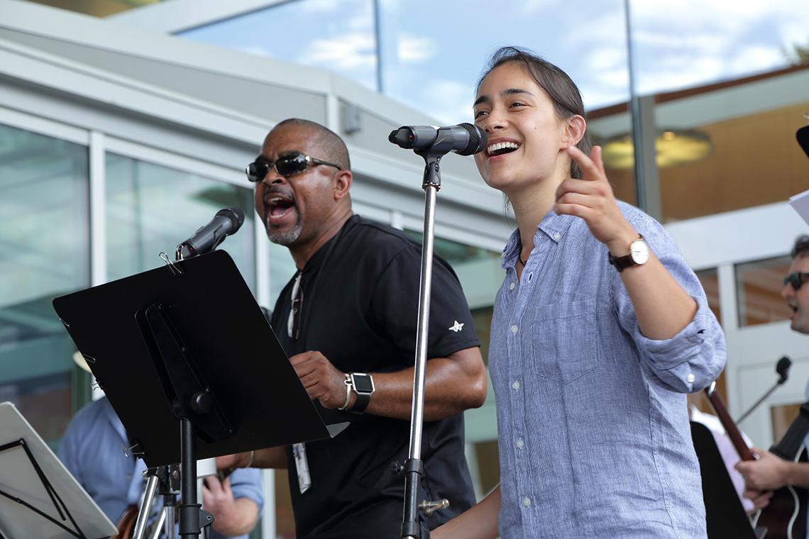Two singers perform on stage.