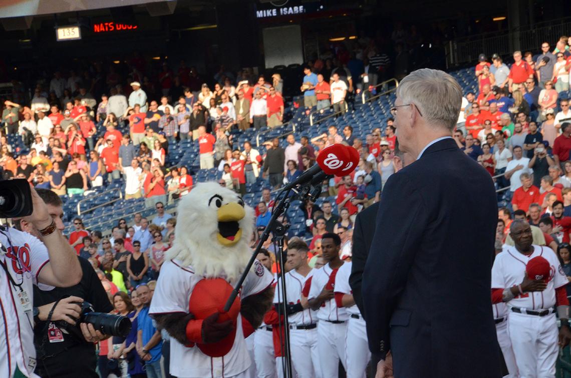 Dr. Collins sings anthem.