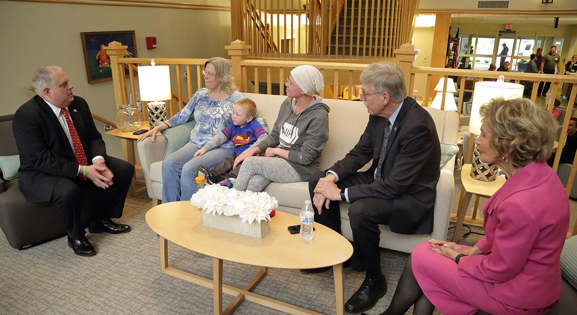 Hogan, Morella and Middleton family sit talking at the Inn.