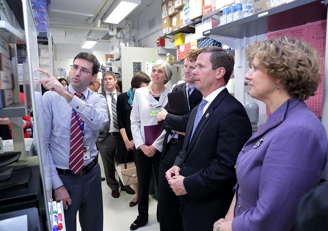 In lab, Hinrichs points toward a whiteboard.
