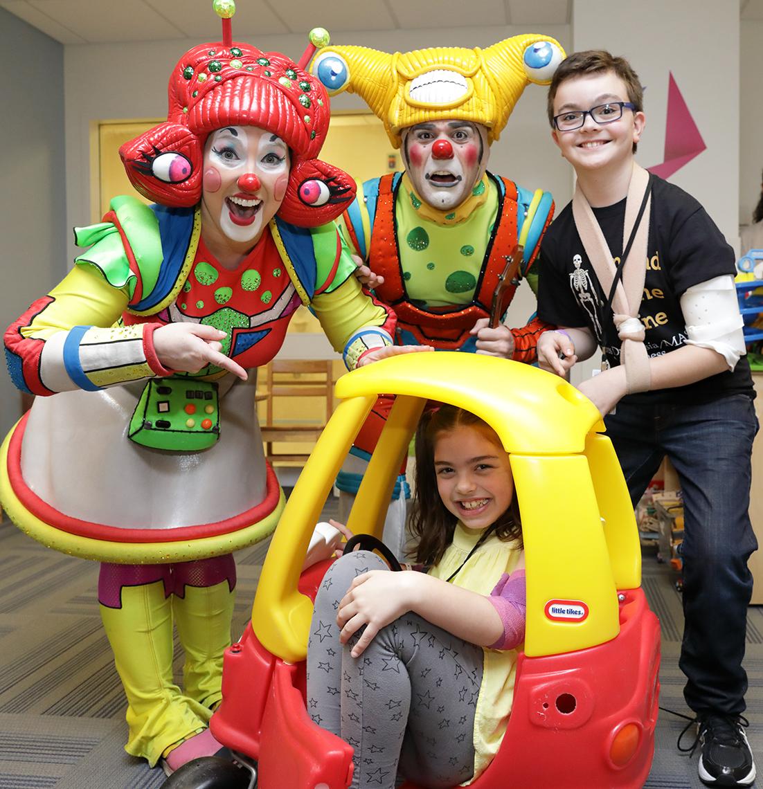 In toy car, driver Ellasyn Berry is joined by circus clowns and Rylan Michael Pederson.