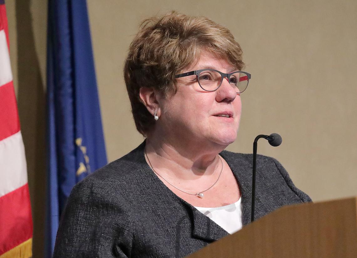 Brennan speaks at podium.