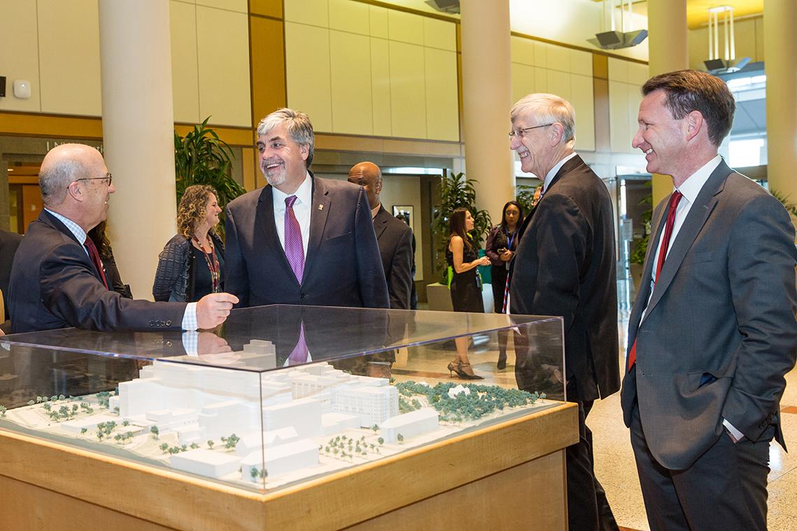 Hargan views model of hospital at NIH.