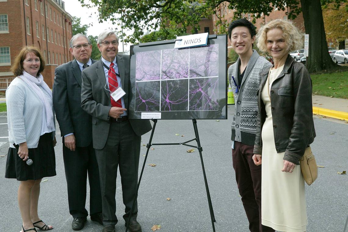 Tabak, Koroshetz and Volkow show art poster of purple swirls