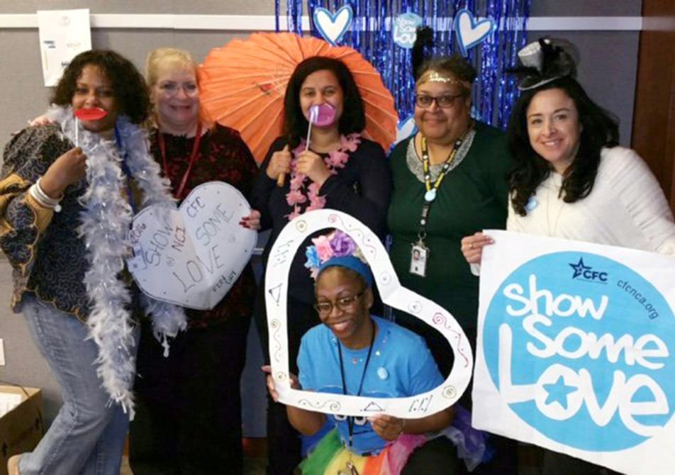 NIH'ers pose together with heart and Show Some Love banner.