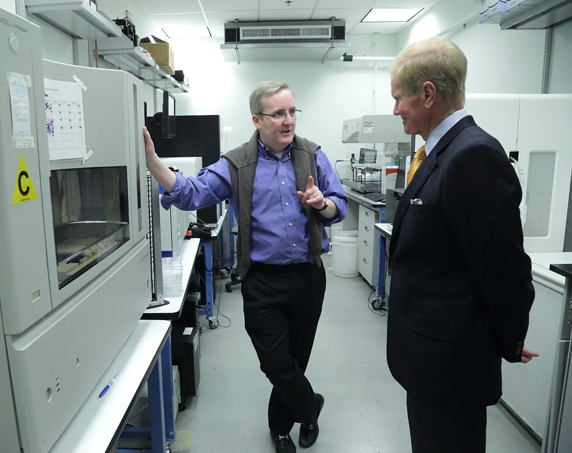 Traynor briefs Nelson in a lab