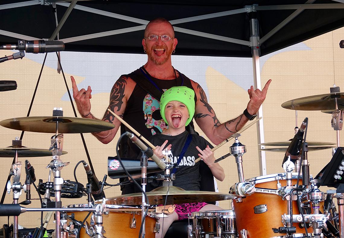 Mackenzie plays the drums with her father