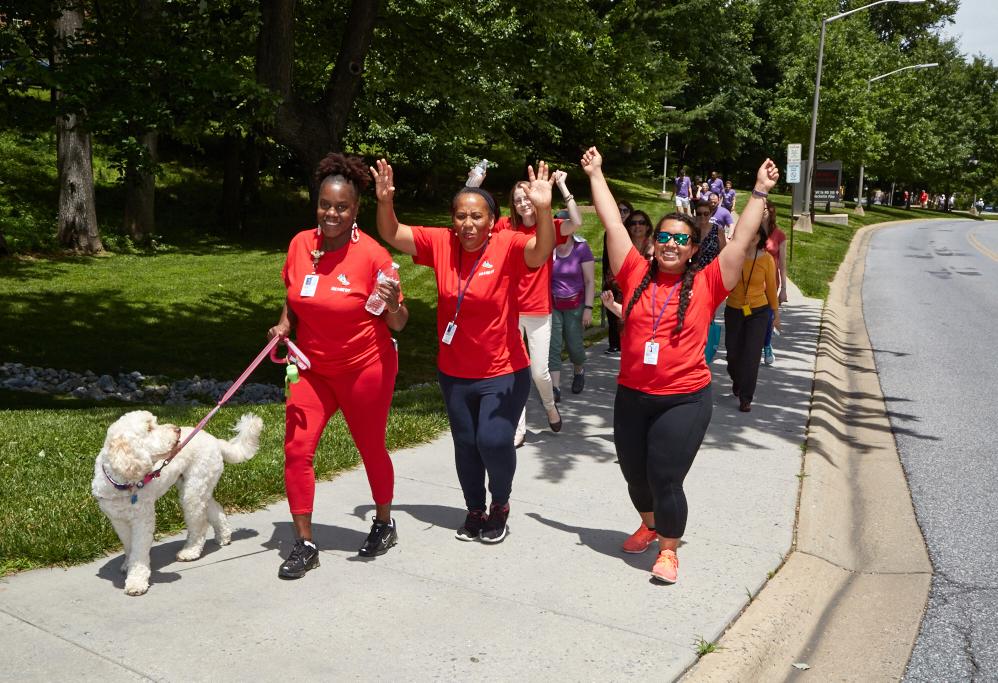 Staff from the Children's Inn walk with their therapy dog, Zilly