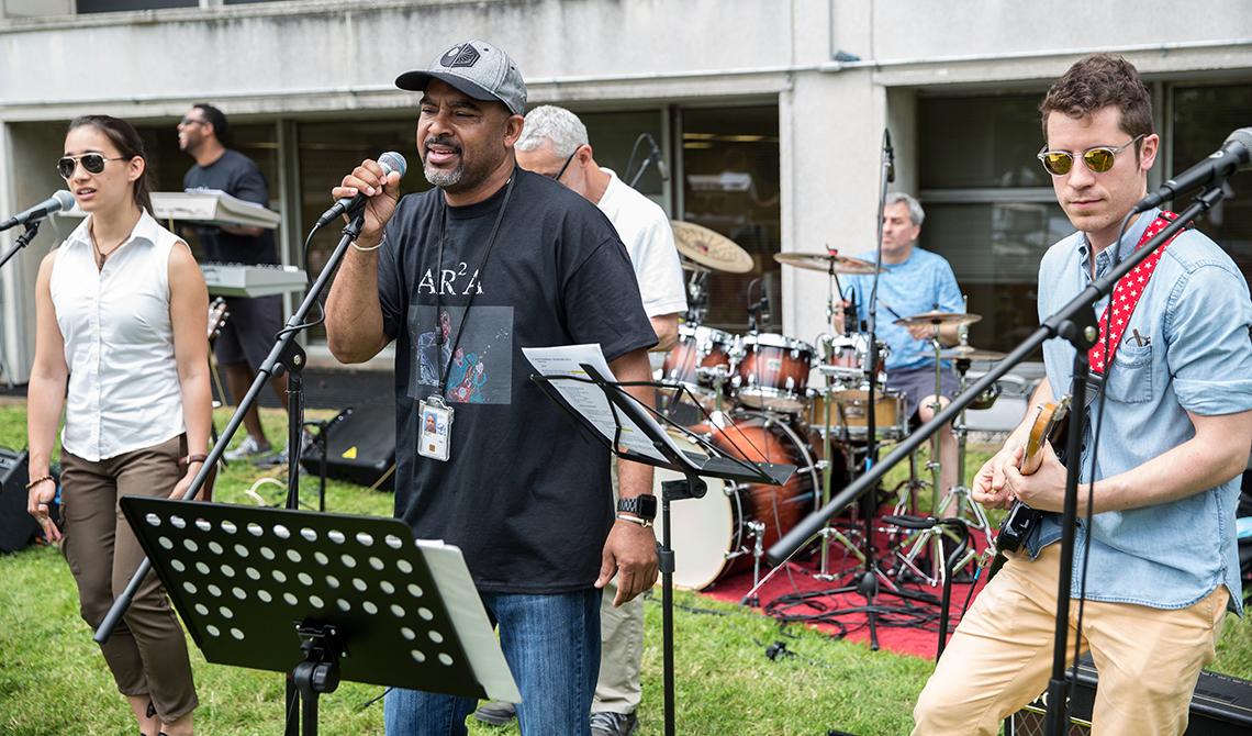 Members of the Directors band perform outside, raise money for charity.