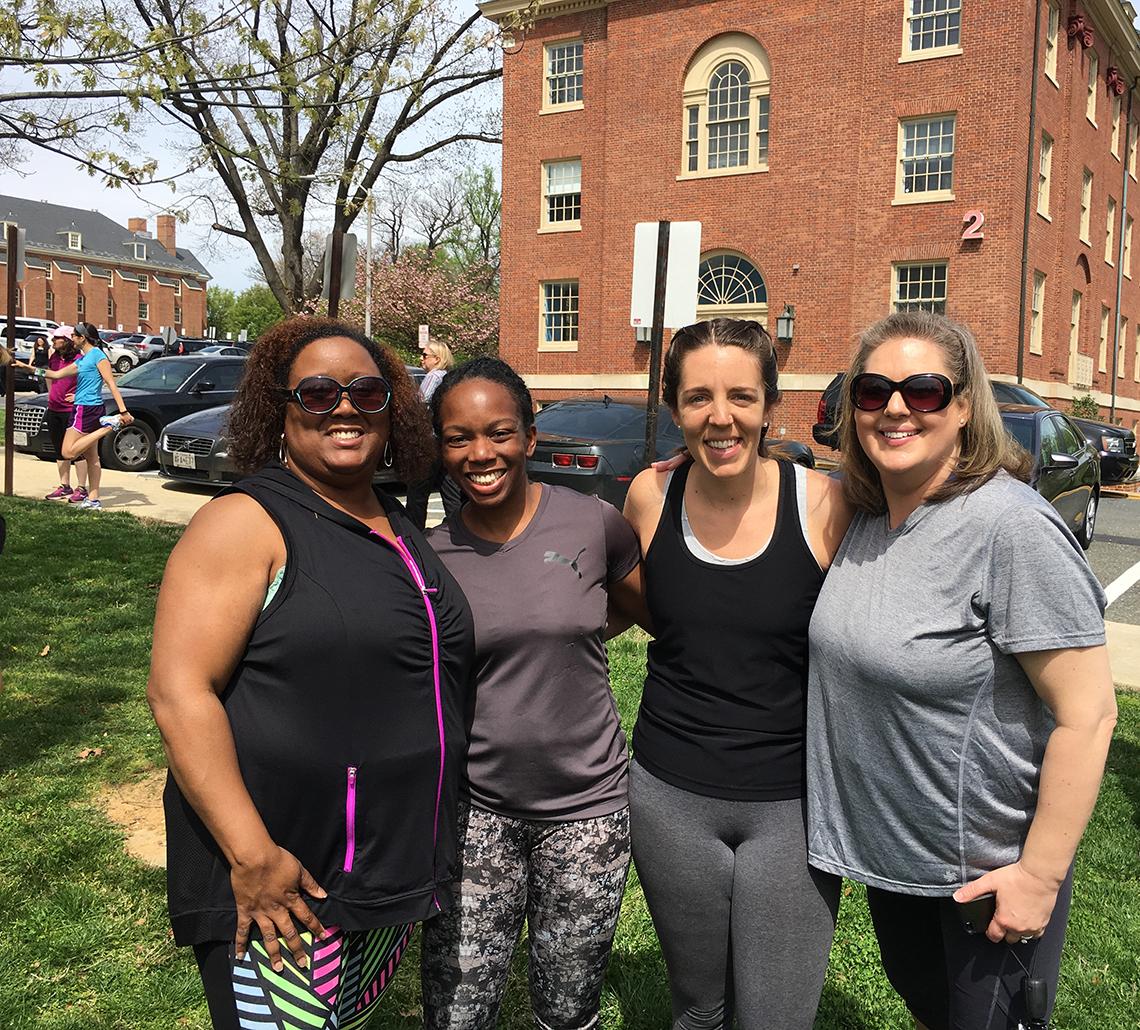 Four staffers pause for a photo