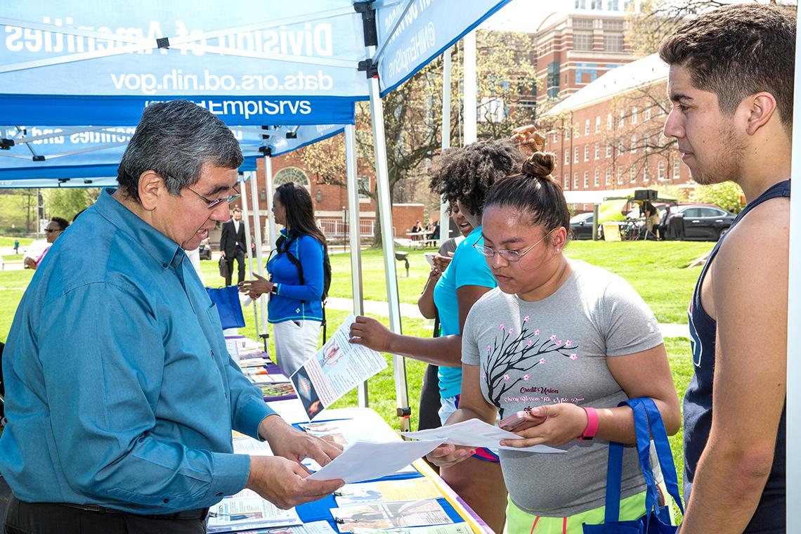 A staffer gives information to participants