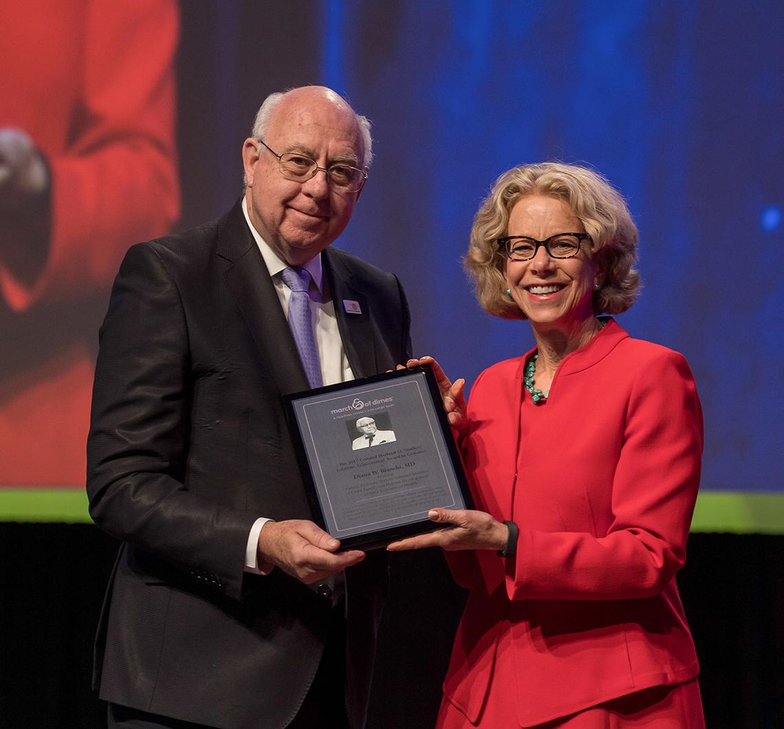 Dr. Bianchi accepts plaque.