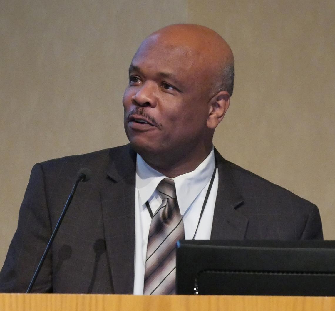 Dr. Johnson speaks at podium.