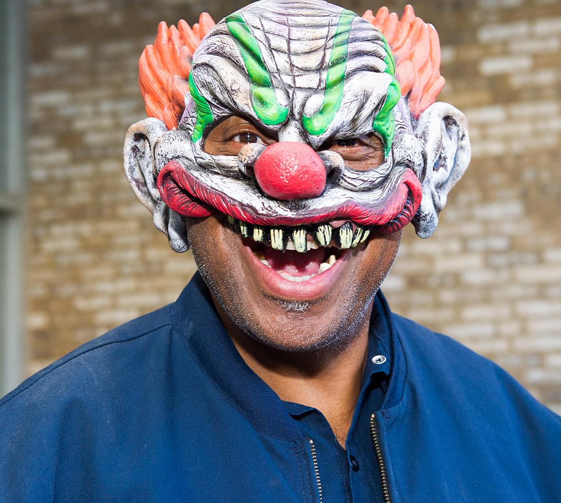 A smiling NIH'er wearing a clown mask
