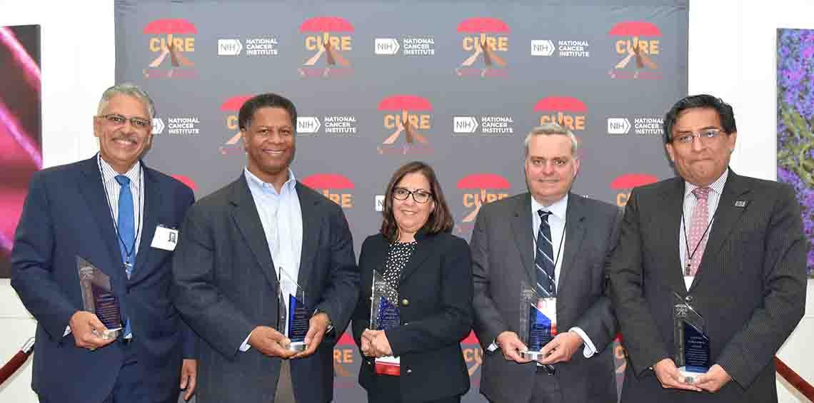 Five honorees smile with their trophies