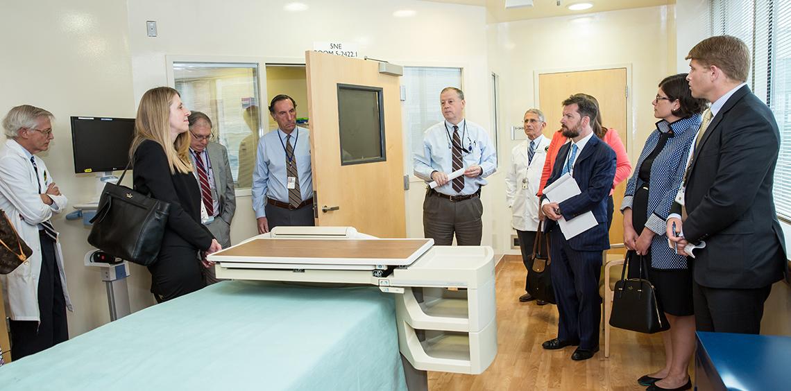 Davey briefs the group, standing in a patient room at the Clinical Center.