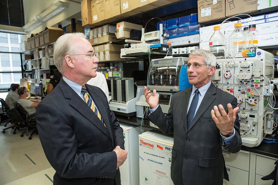 Fauci speaks with Price in a lab