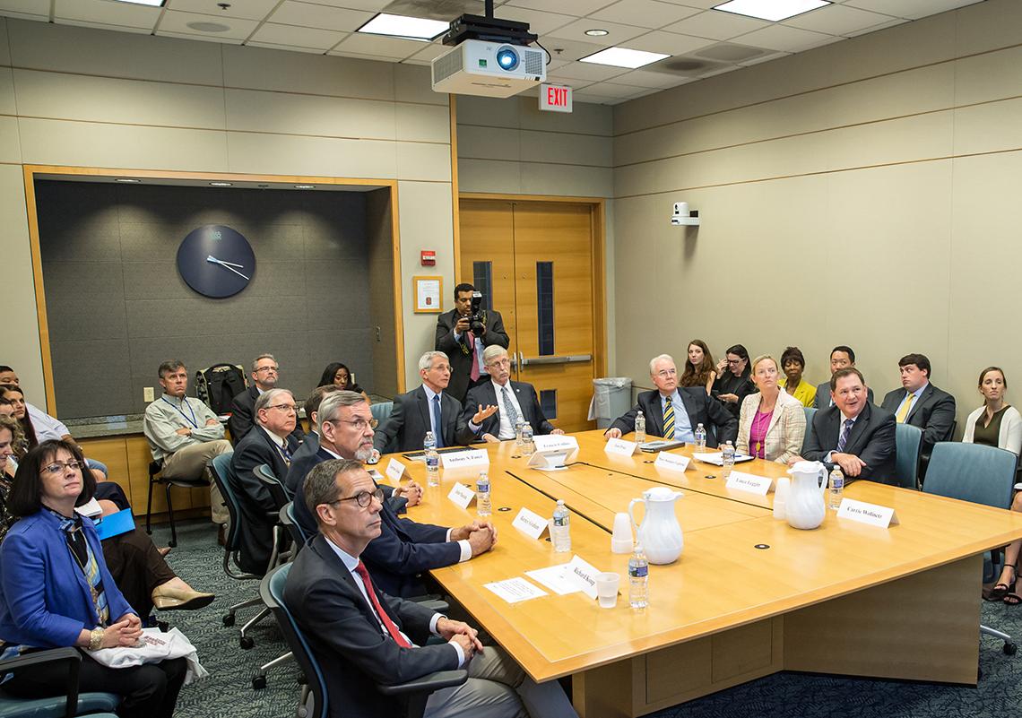 NIH leadership sits around a conference table
