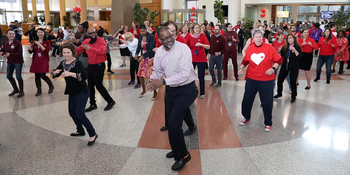NHLBI dir Dr. Gibbons leads line dance at Clinical Center