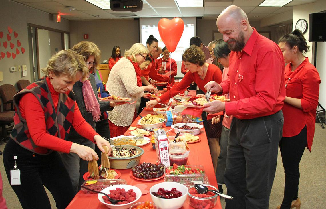 NHLBI staff enjoy a spread of red-colored foods at potluck lunch