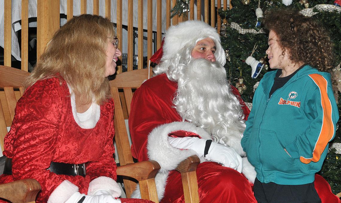 Santa and Mrs. Claus visit with an inn patient.