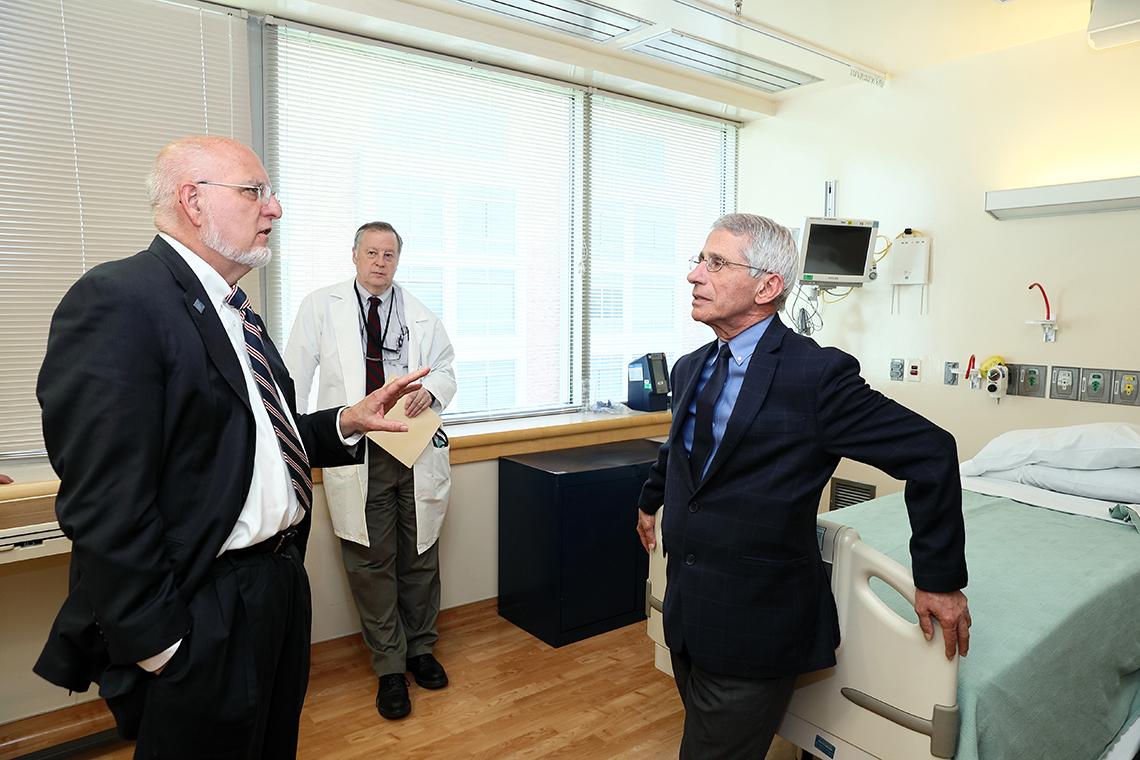 Redfield tours the special clinical studies unit with Fauci and Dr. Richard Davey.