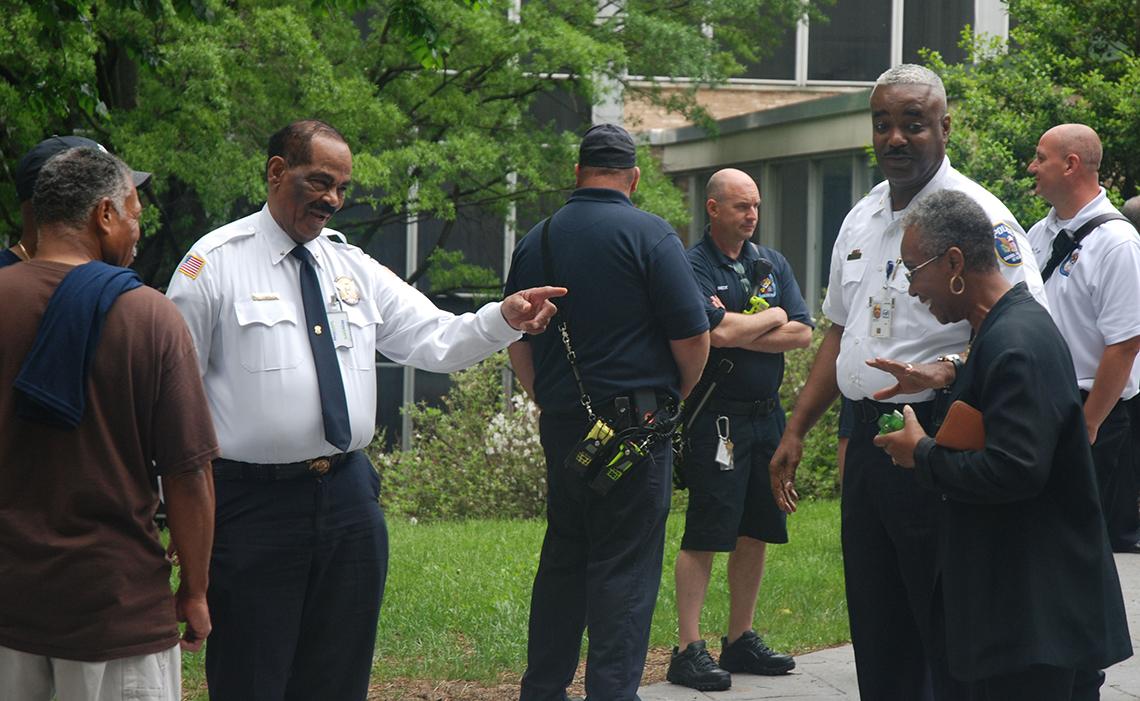 NIH Police Chief Alvin Hinton and Deputy Chief Leslie Campbell share a light moment with attendees.