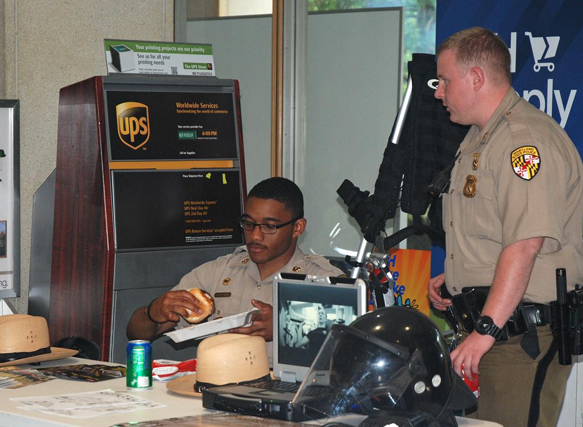 A Maryland State trooper prepares to take a bite out of a burger.