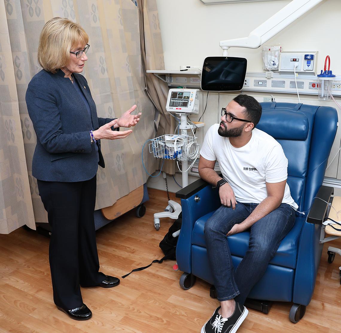 Hassan talks with a patient in NCI’s Pediatric Oncology Branch.