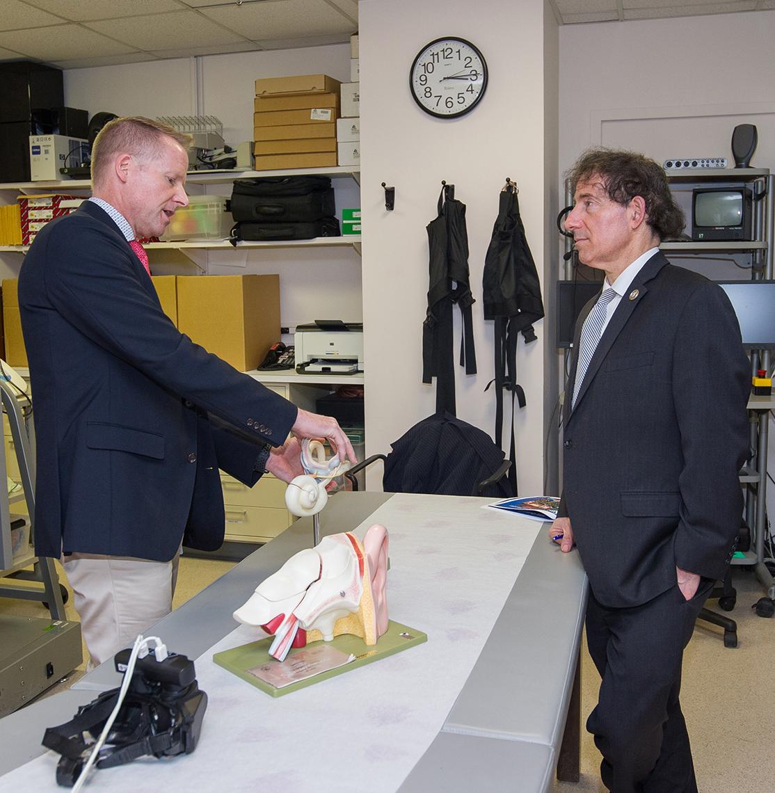 Research audiologist Dr. Chris Zalewski gives a presentation to Raskin.
