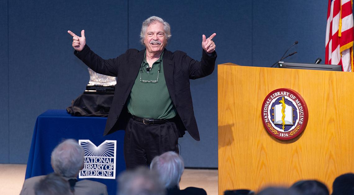 A smiling Dr. Kay on stage