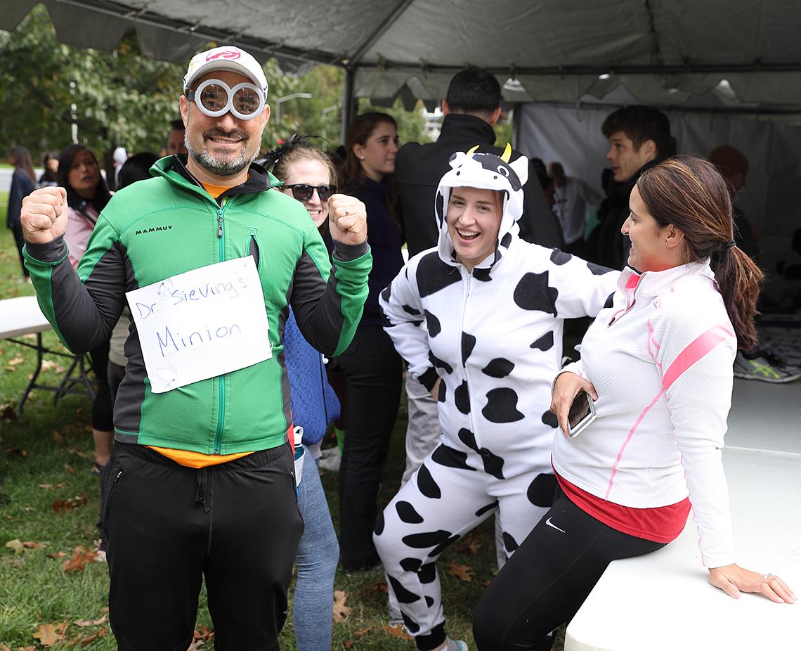 NEI staff dressed in minion and cow costumes goofing off under the tent