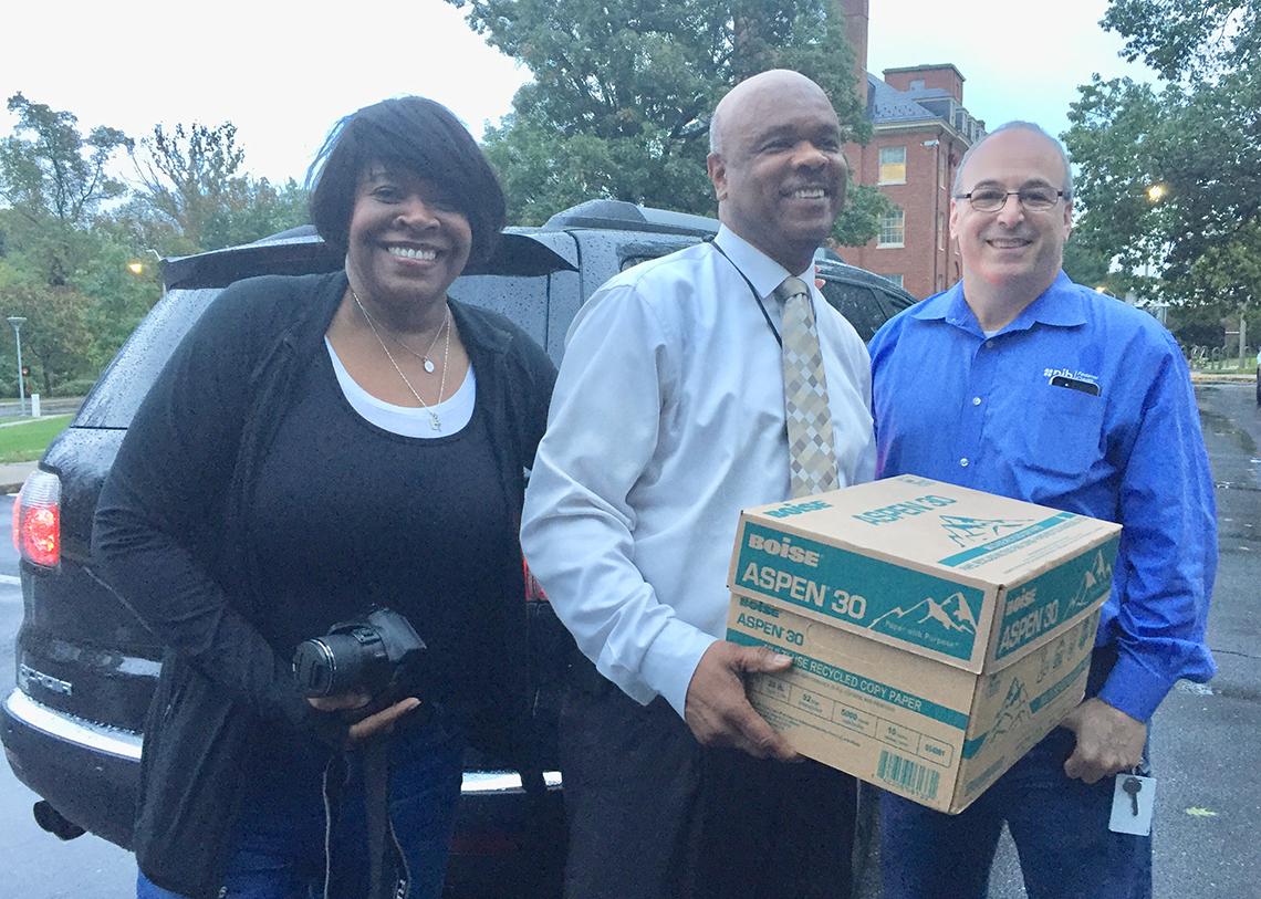 Dr. Johhson carries box of papers to shred with NIHFCU's Hairston and Levin by his side