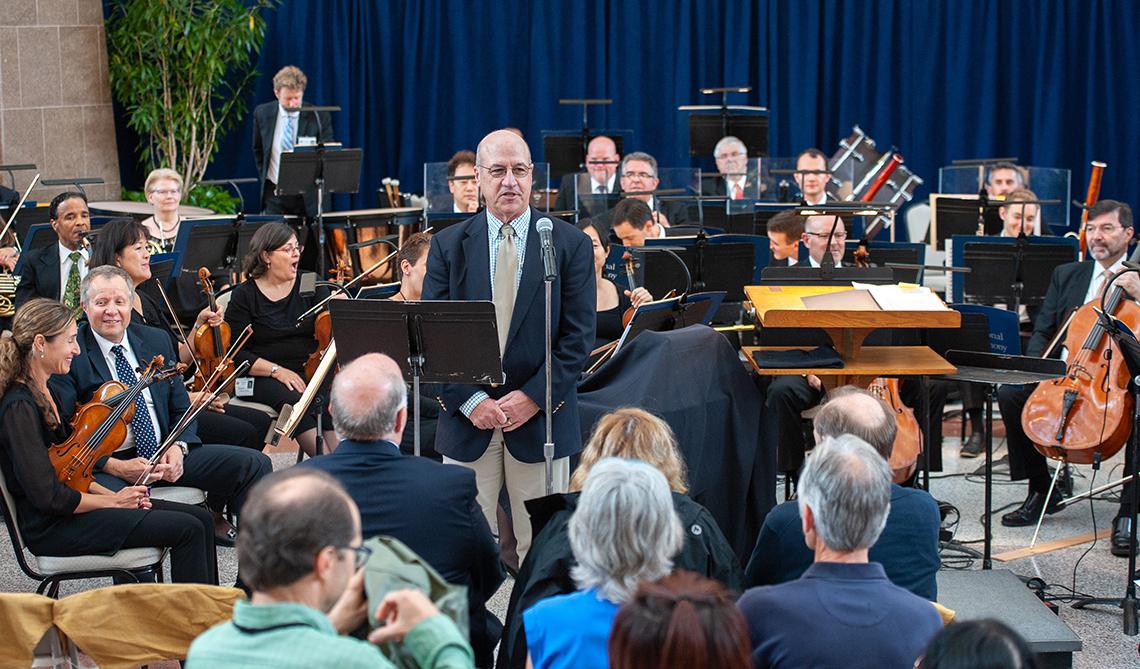 Dr. James Gilman welcomes patients, staff and guests to the NSO performance.
