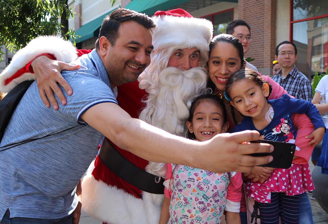Daniel Beltran and Yury Plata Martinez and their daughters take a selfie with Santa.