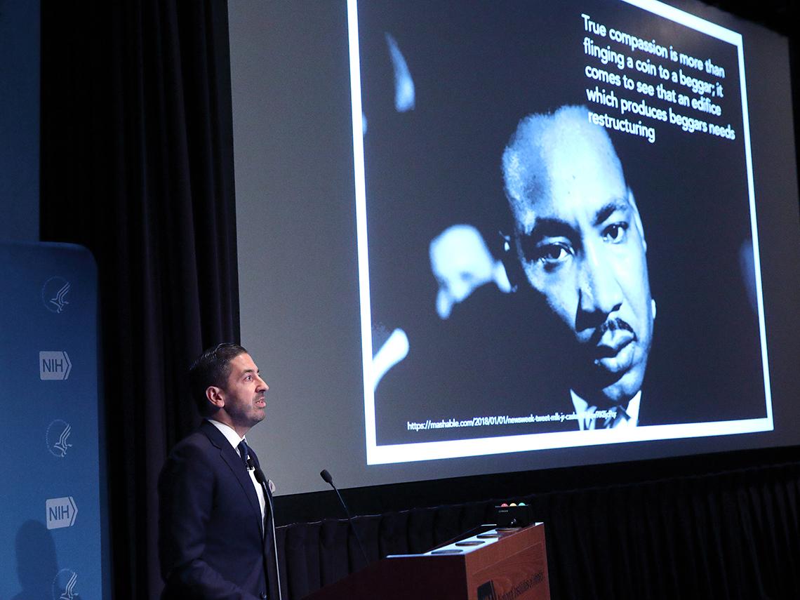 Galea stands next to a slide featuring a photo of Martin Luther King Jr. 